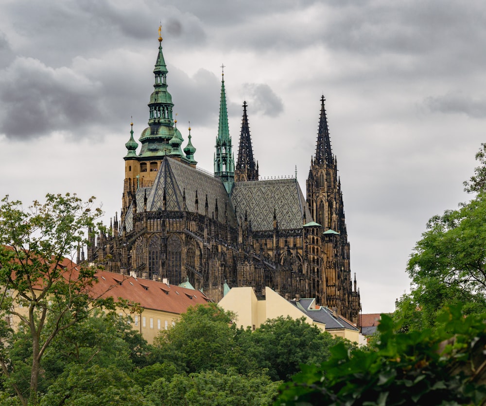 a large cathedral towering over a lush green forest