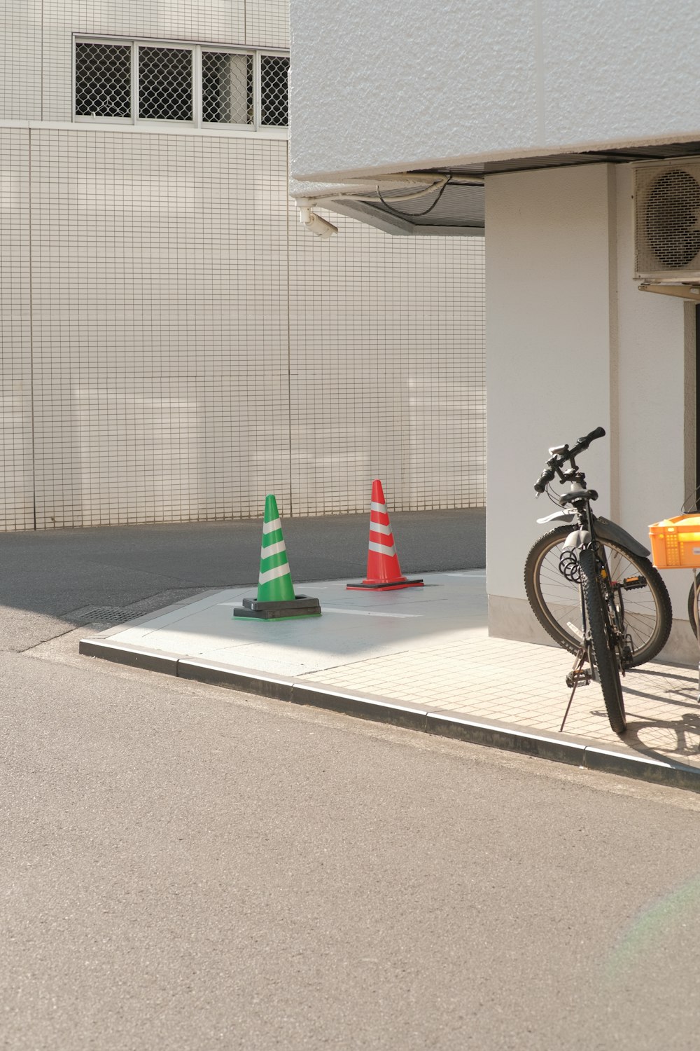 a bicycle is parked next to a traffic cone