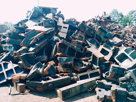 Close-up of various scrap metals piled together outdoors
