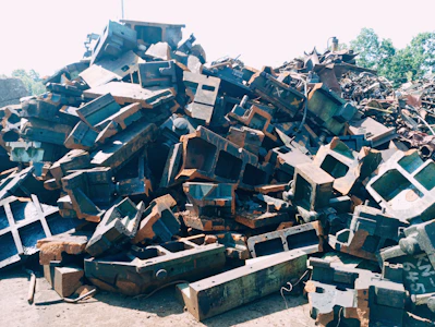 Close-up of various scrap metal pieces piled together outdoors