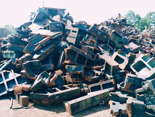 Photo of aluminum scrap piles ready for recycling at KLL Scrap Metal Co yard on a sunny day.