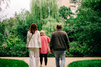 a man and two women walking down a sidewalk