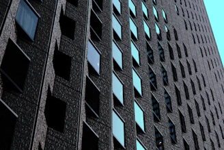 Close-up shot of a sleek, polished luxury building facade emphasizing texture and light play.