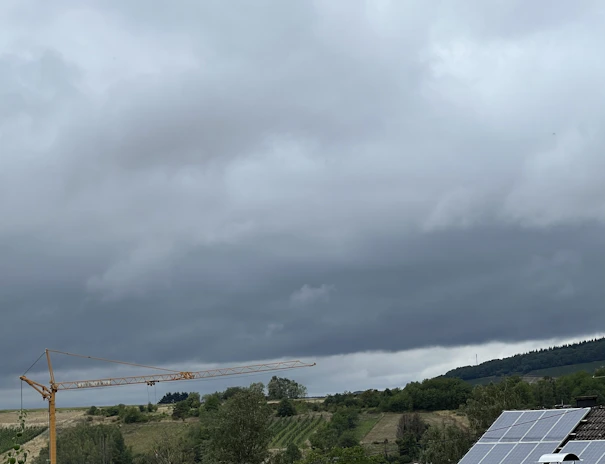 A panoramic view of a large-scale solar EPC project in progress with cranes and workers ensuring rapid, safe construction.