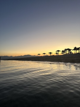 A tranquil beach on Gili Iyang during sunset.