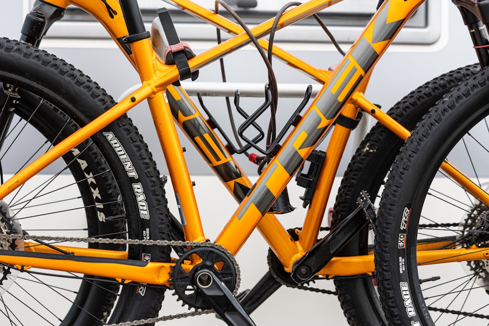 a close up of a yellow bike with black spokes