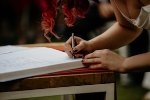 An author signing books at a lively event.