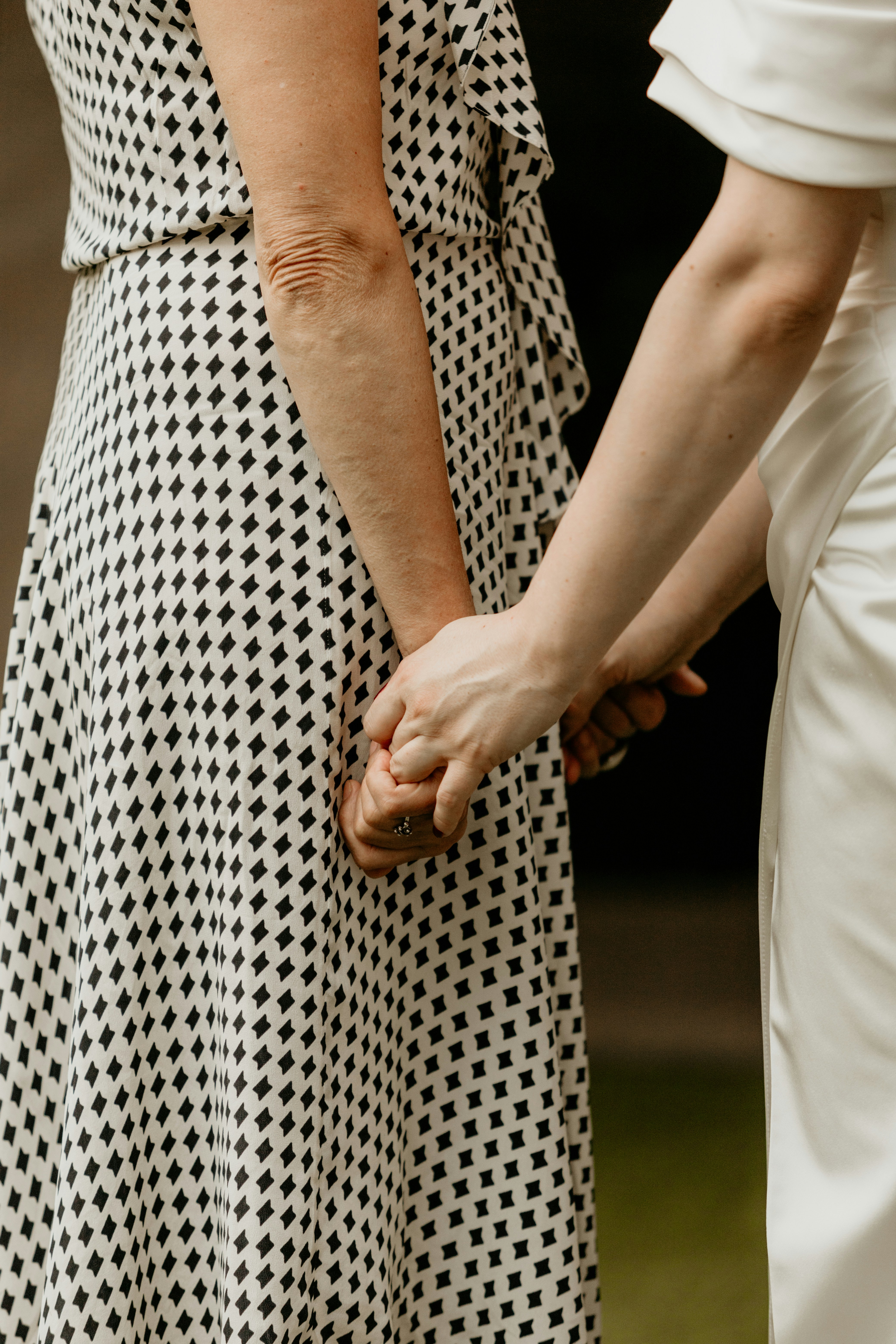 a close up of two people holding hands