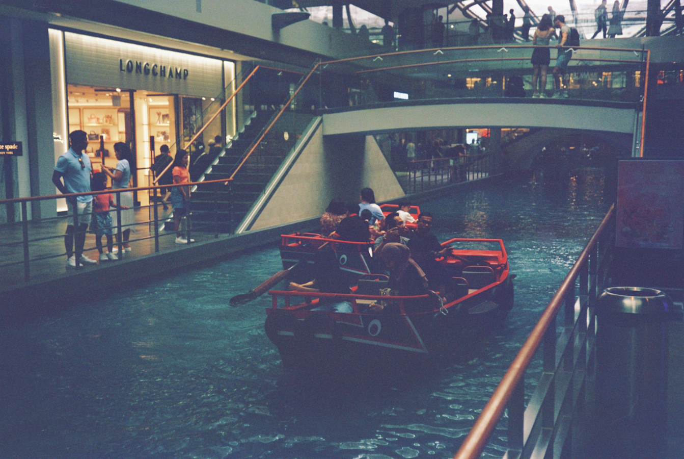 a group of people riding in a boat down a river
