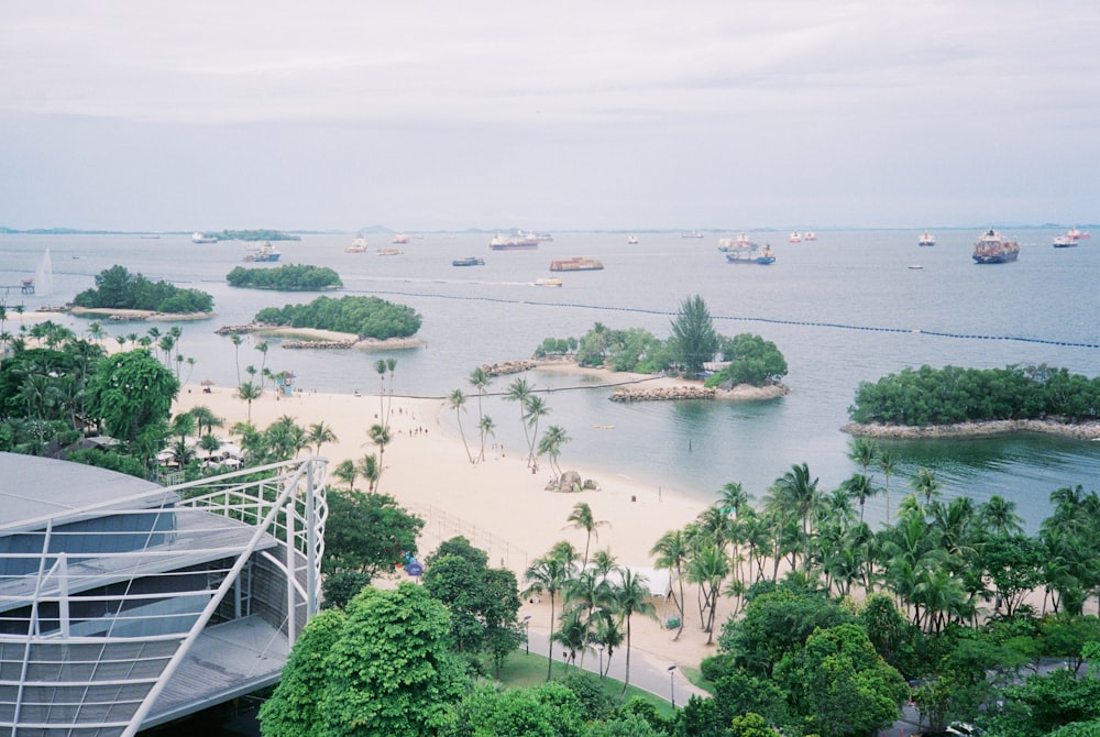 an aerial view of a beach with boats in the water