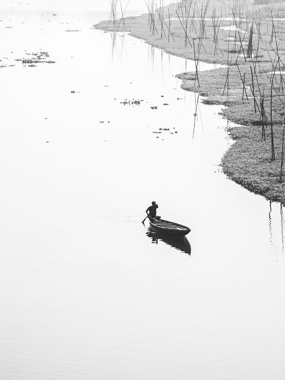 a person in a small boat on a body of water