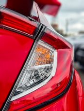 a close up of the tail light of a red car