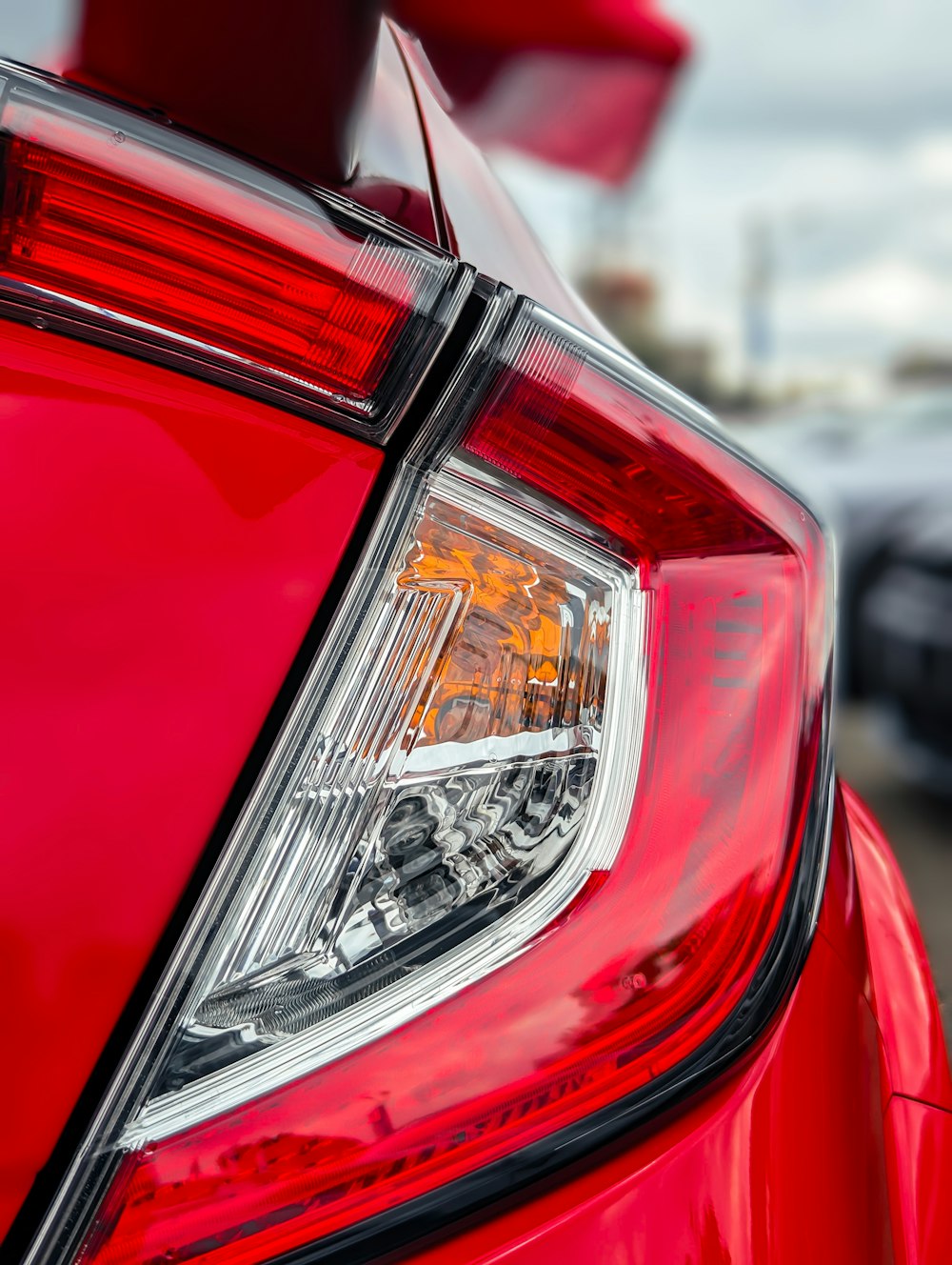 a close up of the tail light of a red car