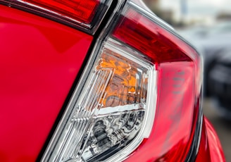 a close up of the tail light of a red car