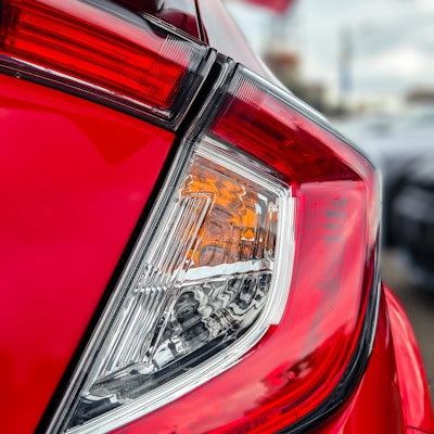 a close up of the tail light of a red car