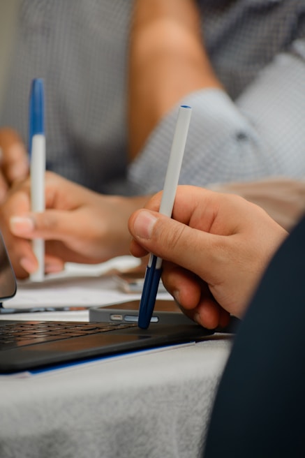 Close-up of hands working together on digital marketing strategies