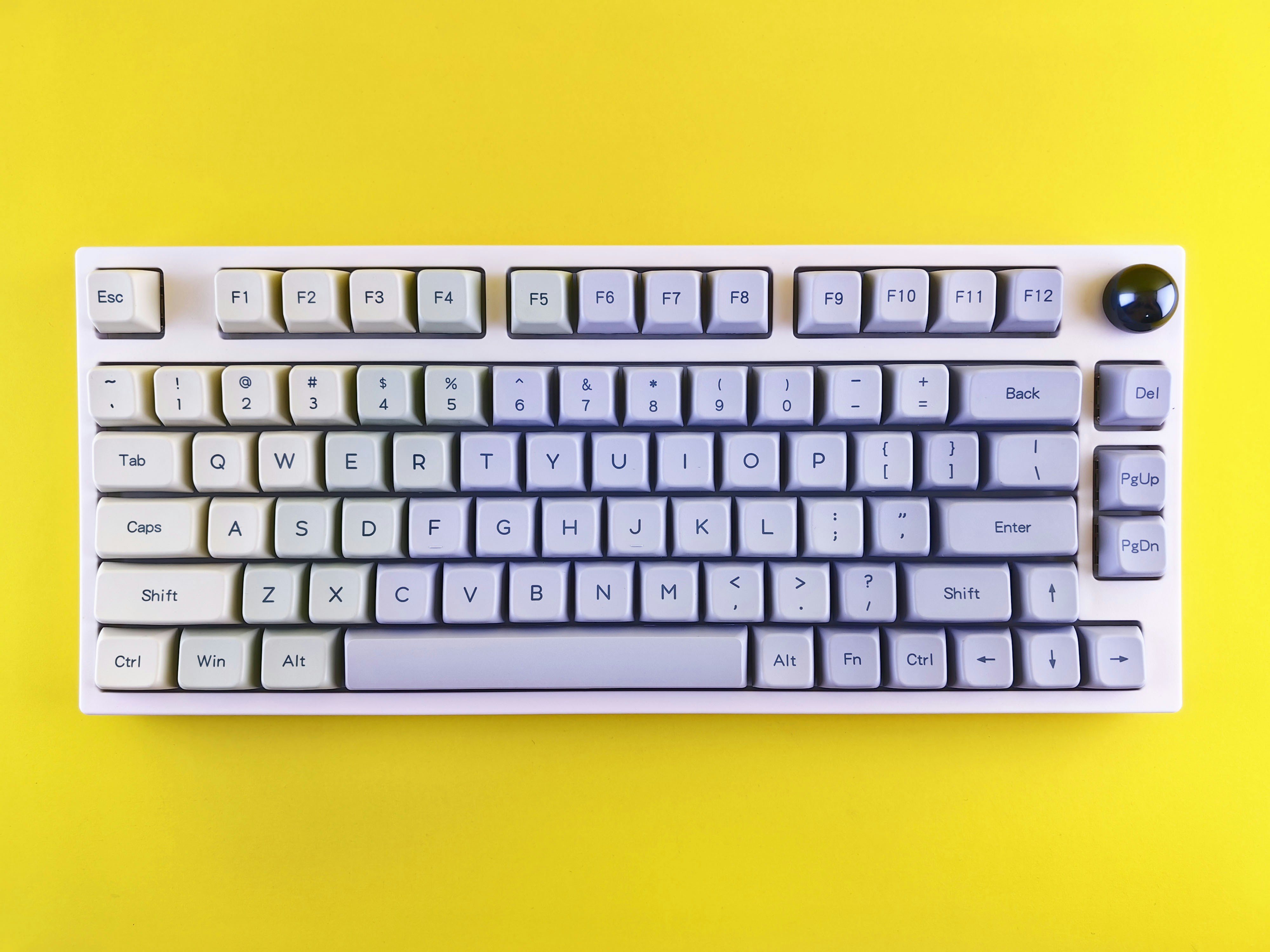 a computer keyboard sitting on top of a yellow surface