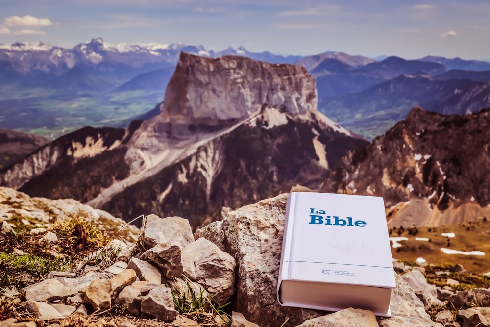a bible sitting on top of a rocky mountain