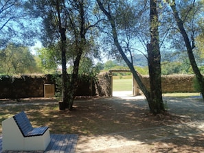 A serene outdoor scene with charcoal black benches and soft blue sky.
