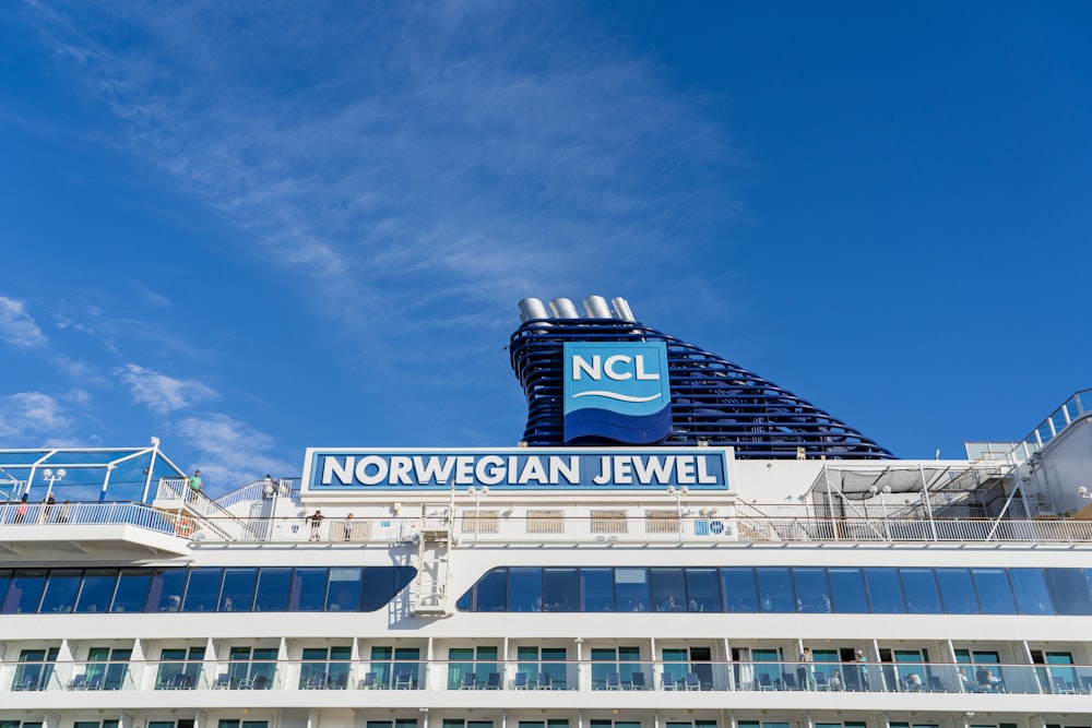 a cruise ship with a sign on top of it