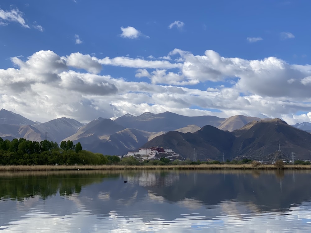 a body of water with mountains in the background