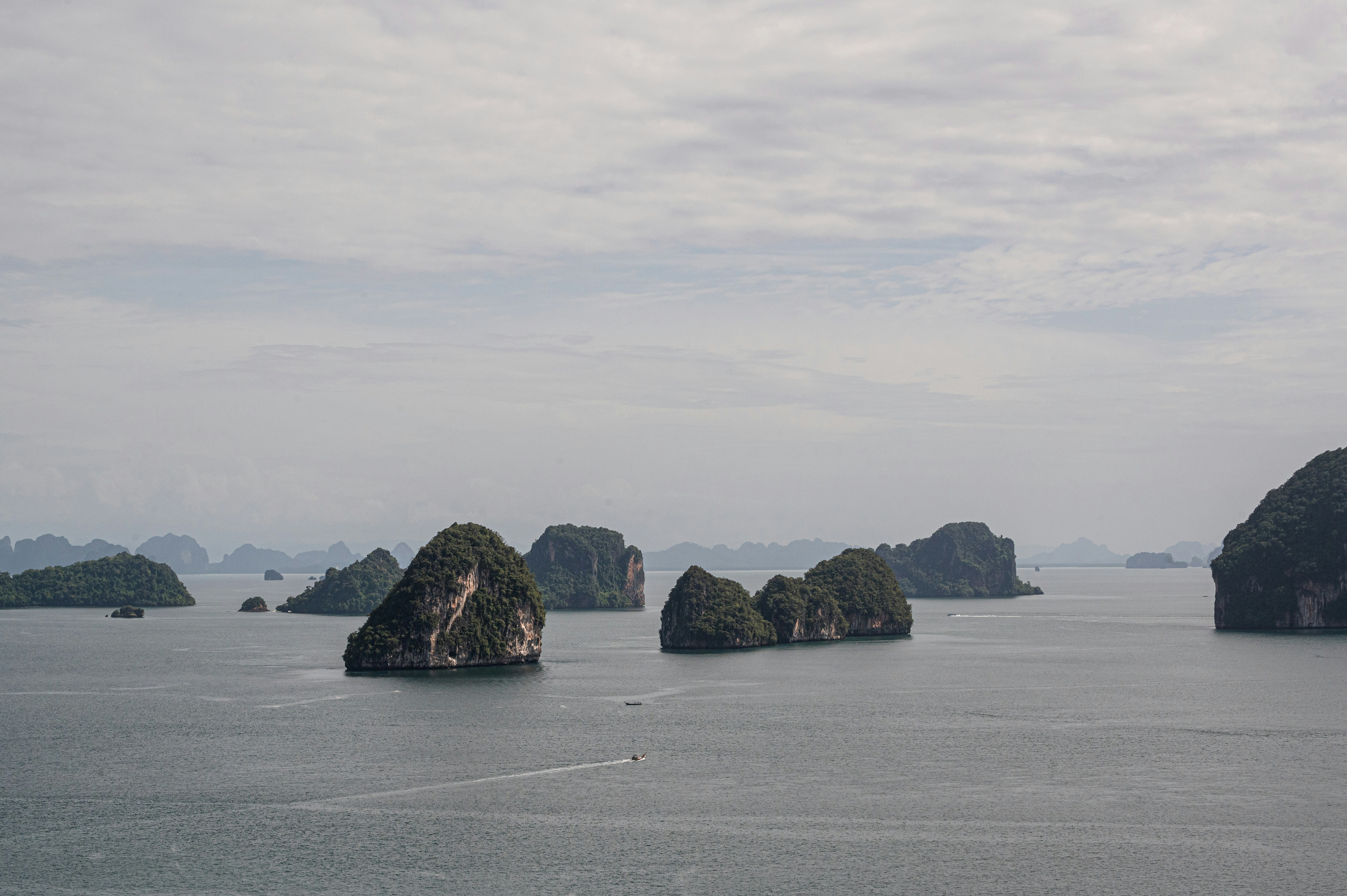 a group of rocks in the middle of a body of water