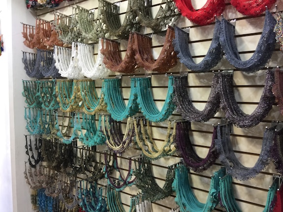 A stunning display of stainless steel necklaces in various colors.