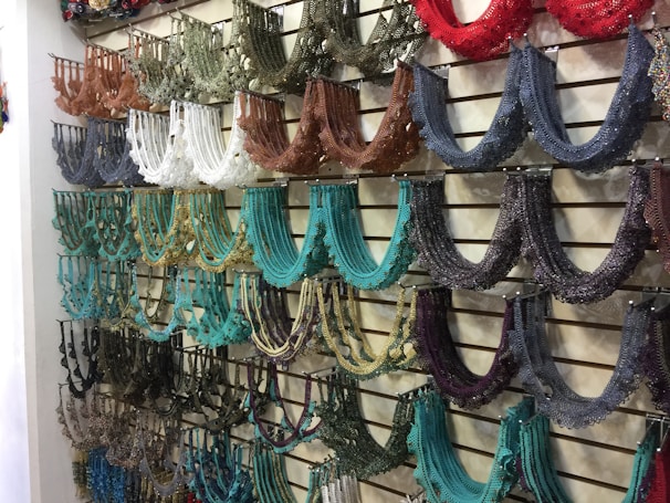 A colorful assortment of pet collars displayed on a wooden table.