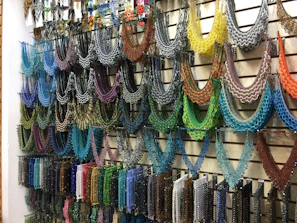 A vibrant display of handcrafted bead jewelry and mandala art ready for international shipping.