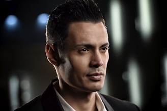 Professional portrait of Pedro Henrique Bermúdez in a modern office setting, wearing a dark suit and glasses.