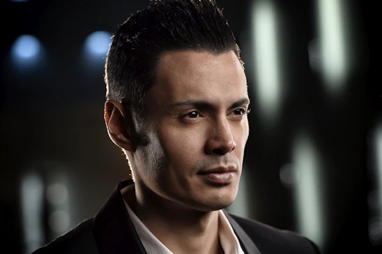 Professional portrait of Vishal Runani in a clean, minimal setting with a navy blue background.