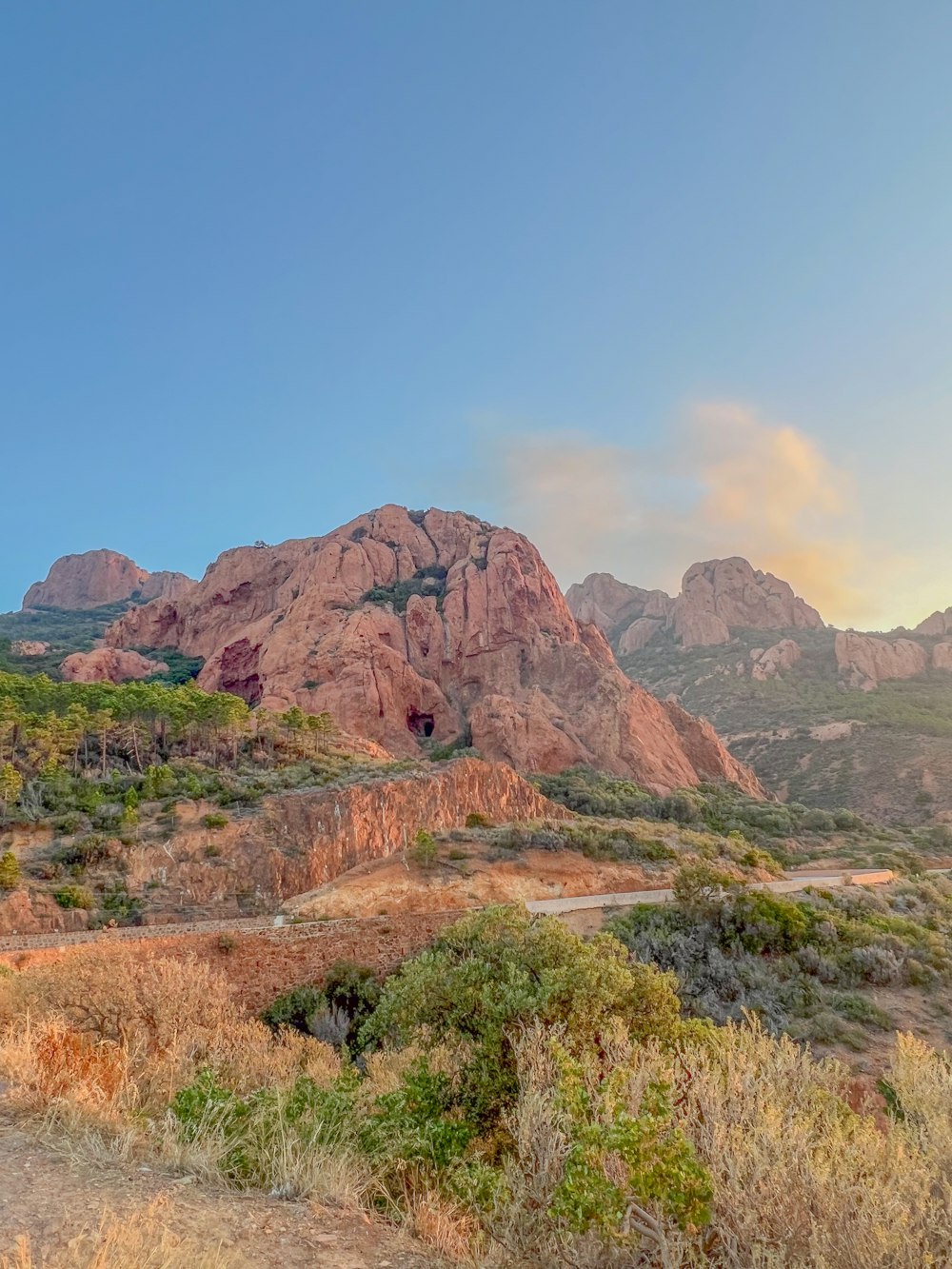 a scenic view of a mountain range at sunset