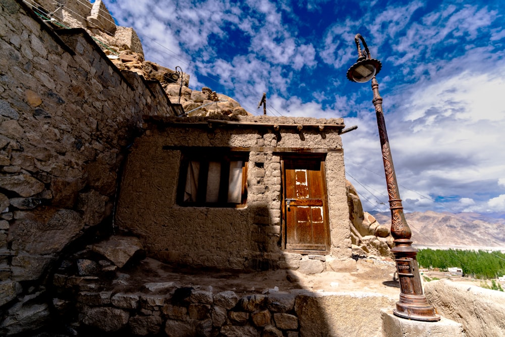 a street light sitting next to a stone building