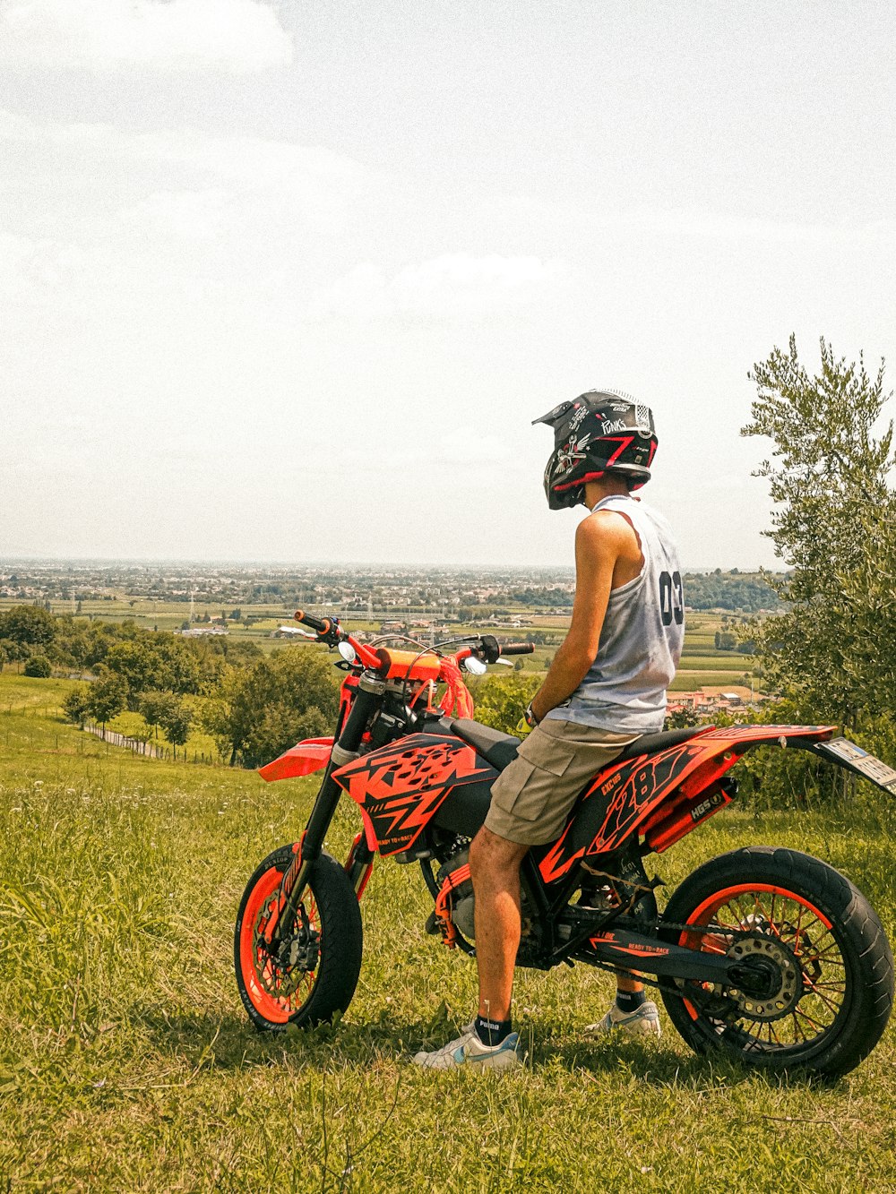 a person sitting on a dirt bike in a field