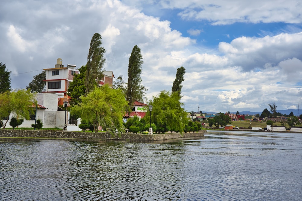 a large body of water with a house in the background