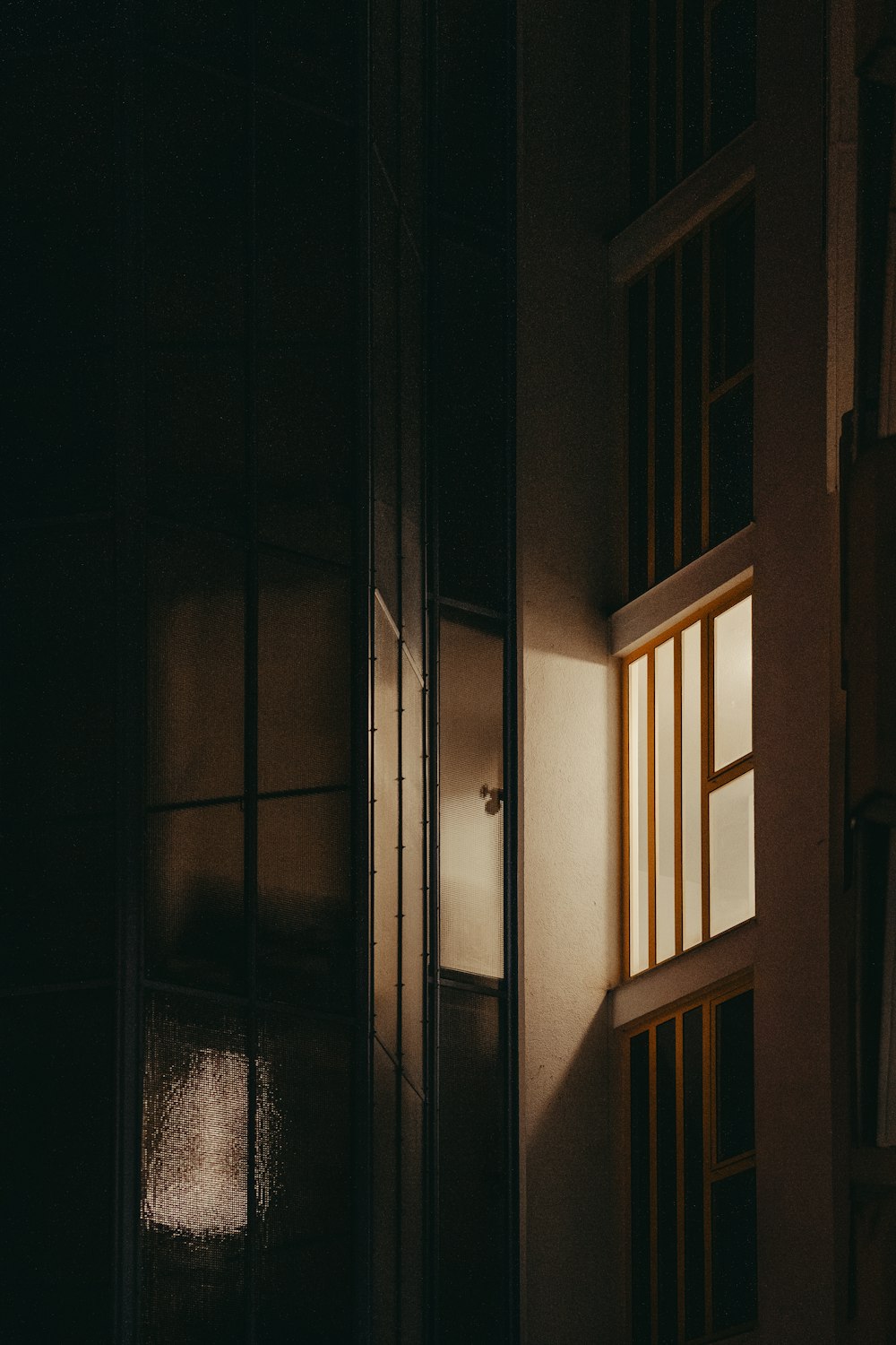 a dark room with a light coming through the window