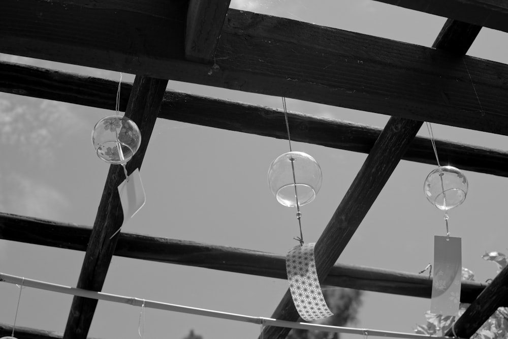 a black and white photo of a tie hanging from a wooden structure
