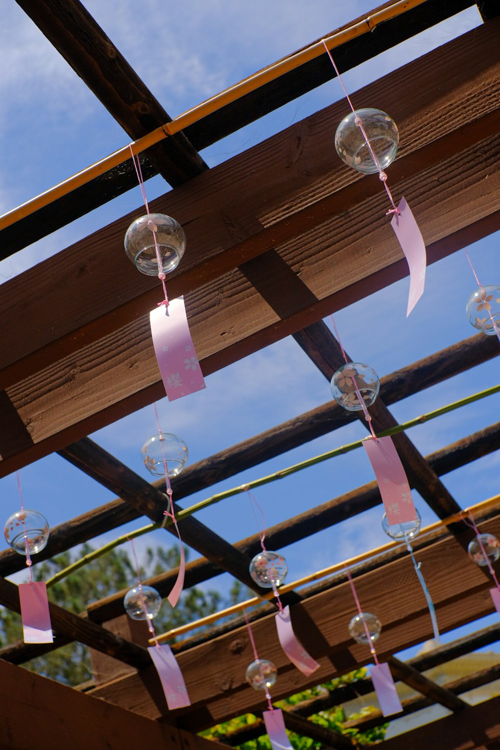 a group of bubbles hanging from a wooden structure