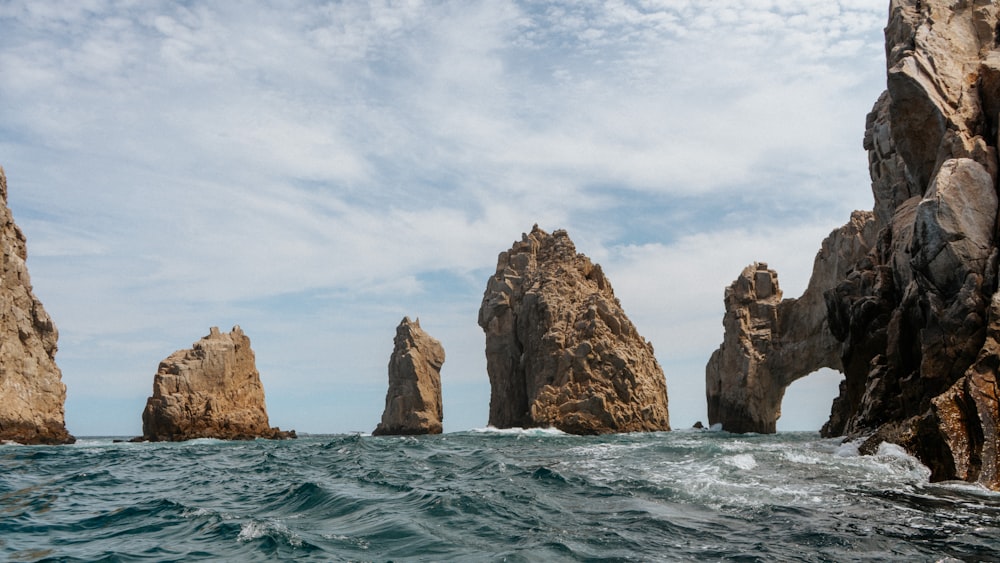 a group of rocks in the middle of the ocean