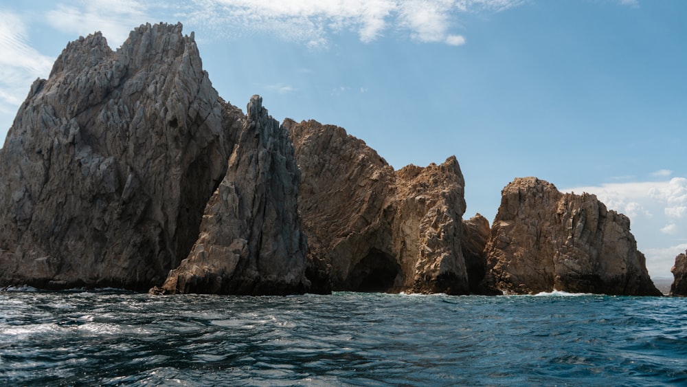 a large rock formation in the middle of the ocean