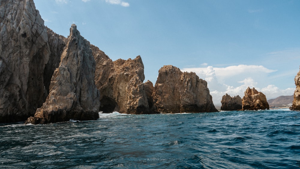 a large body of water with rocks in the background