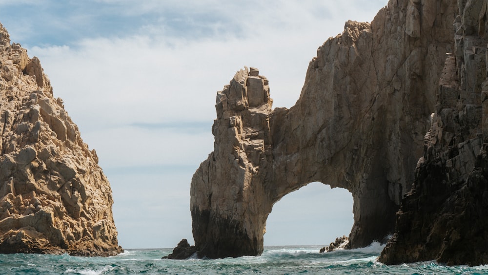 a large rock formation in the middle of the ocean