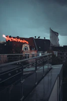 A moody charcoal and green-lit display of werkshade gear on a futuristic urban rooftop.