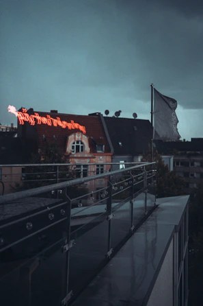 A moody charcoal and green-lit display of werkshade gear on a futuristic urban rooftop.