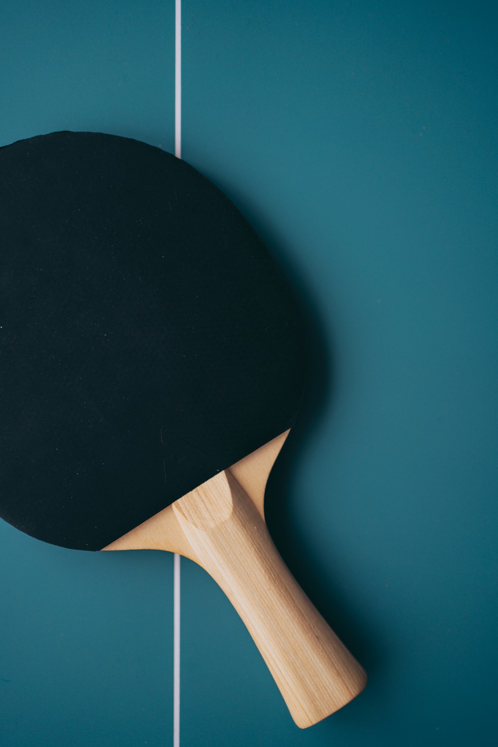 a ping pong paddle resting on a ping pong table