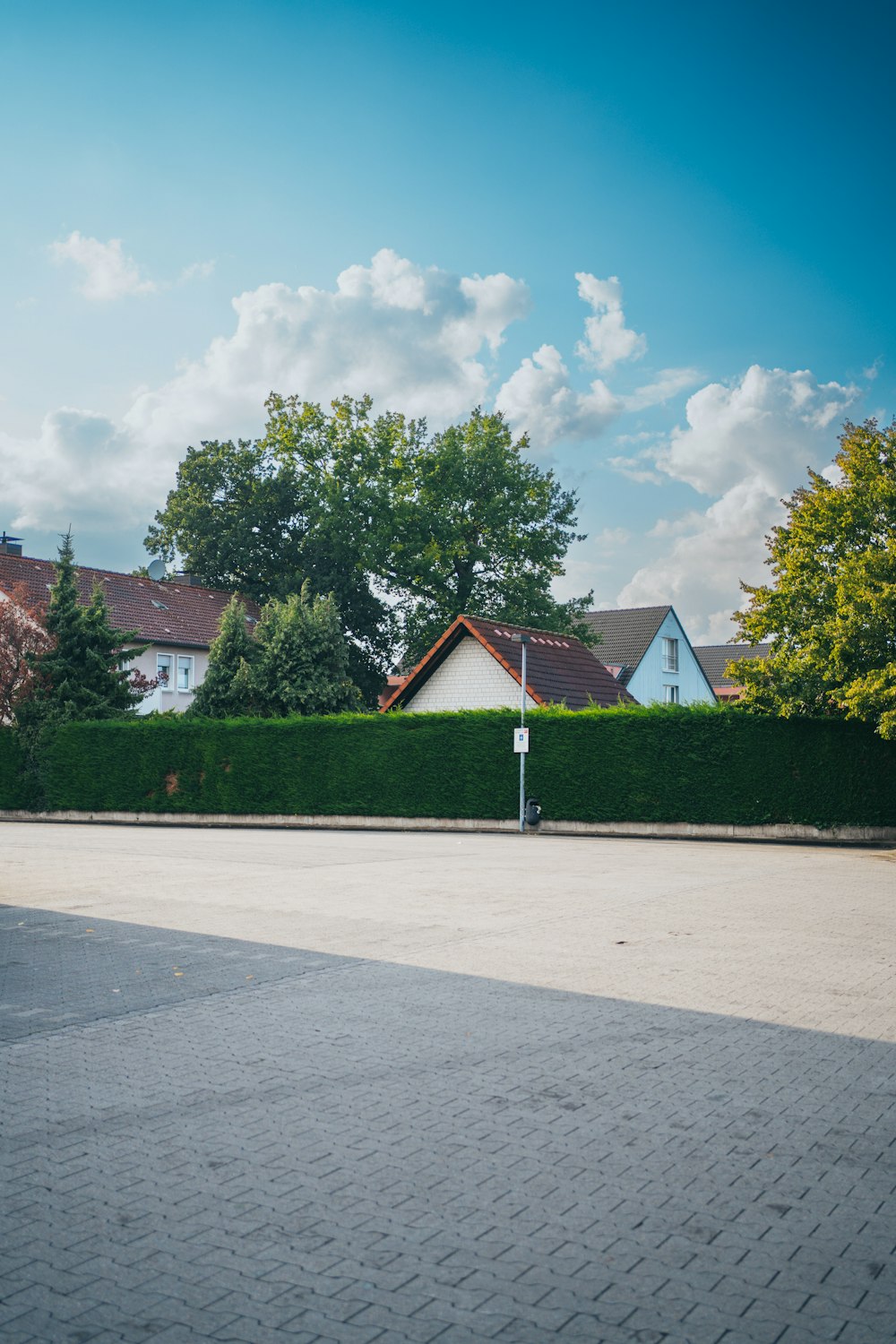 an empty street with a house in the background