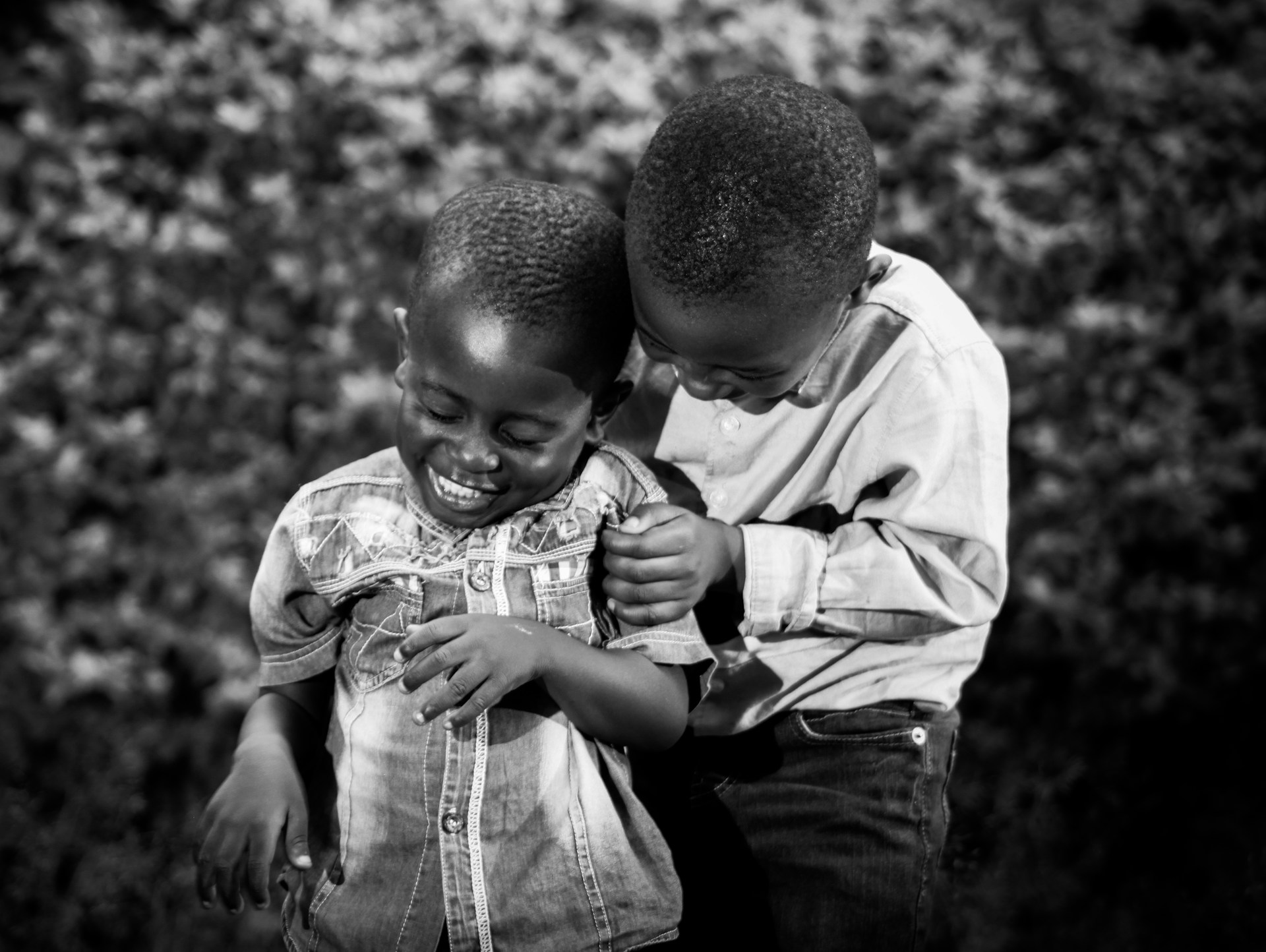 a couple of young boys standing next to each other