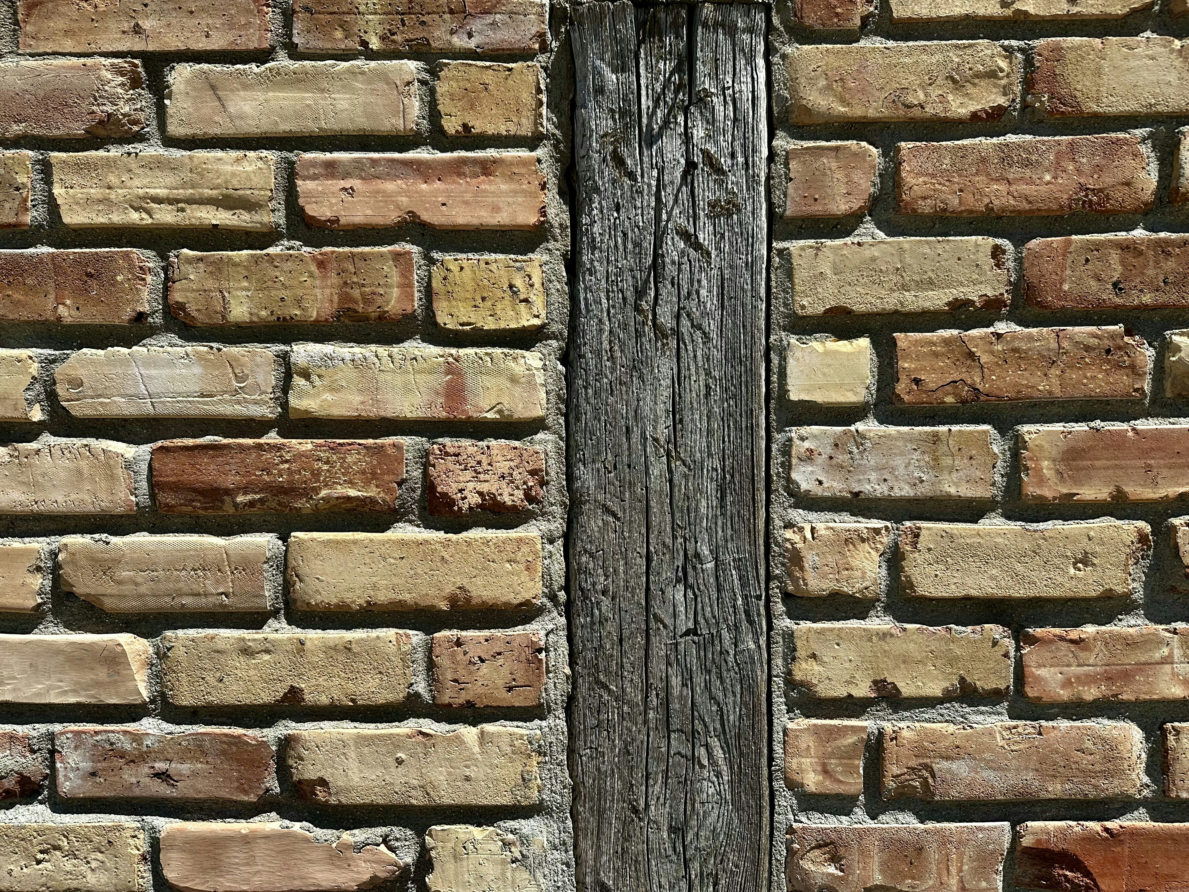 a brick wall with a wooden door in it