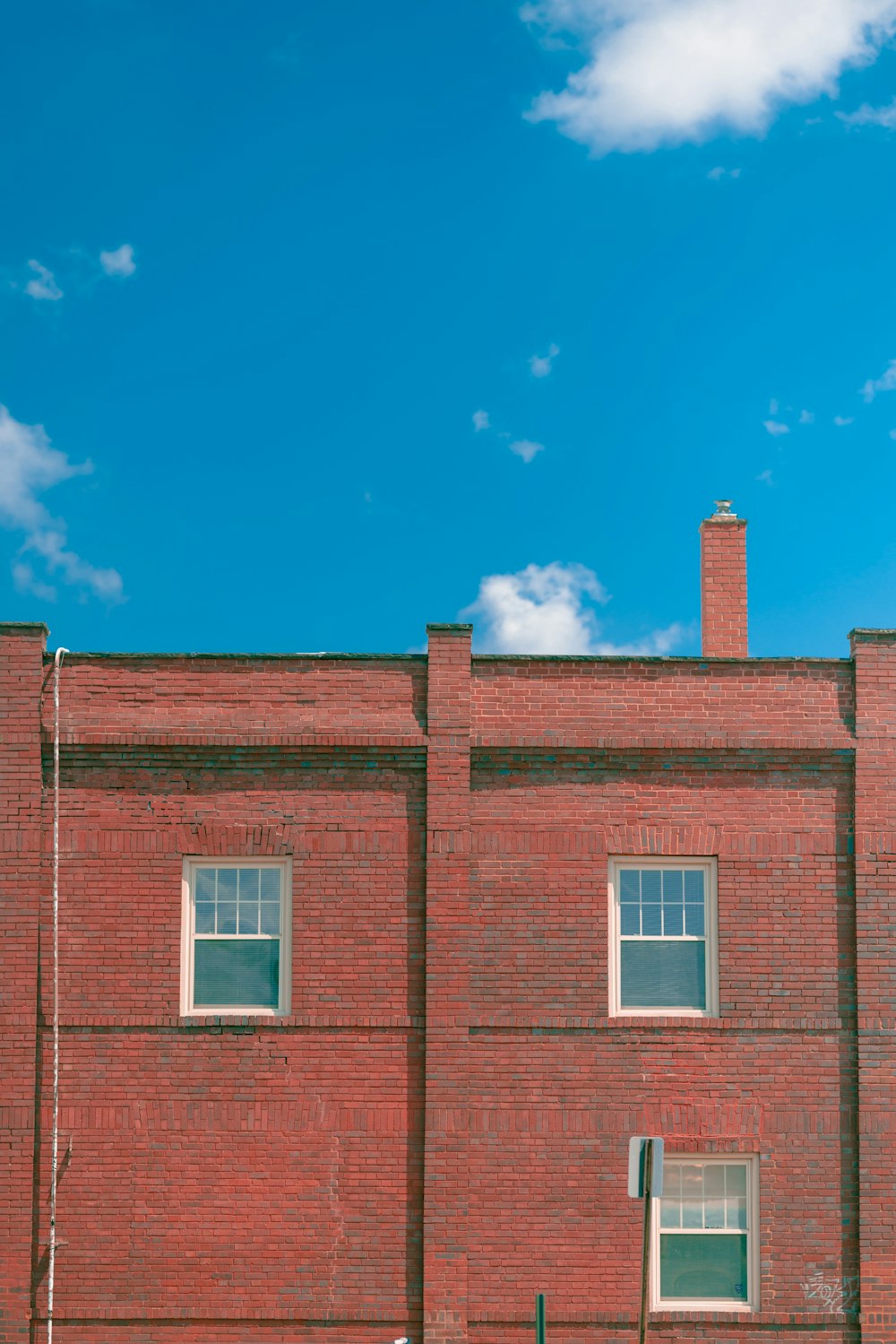 a red brick building with a street sign in front of it