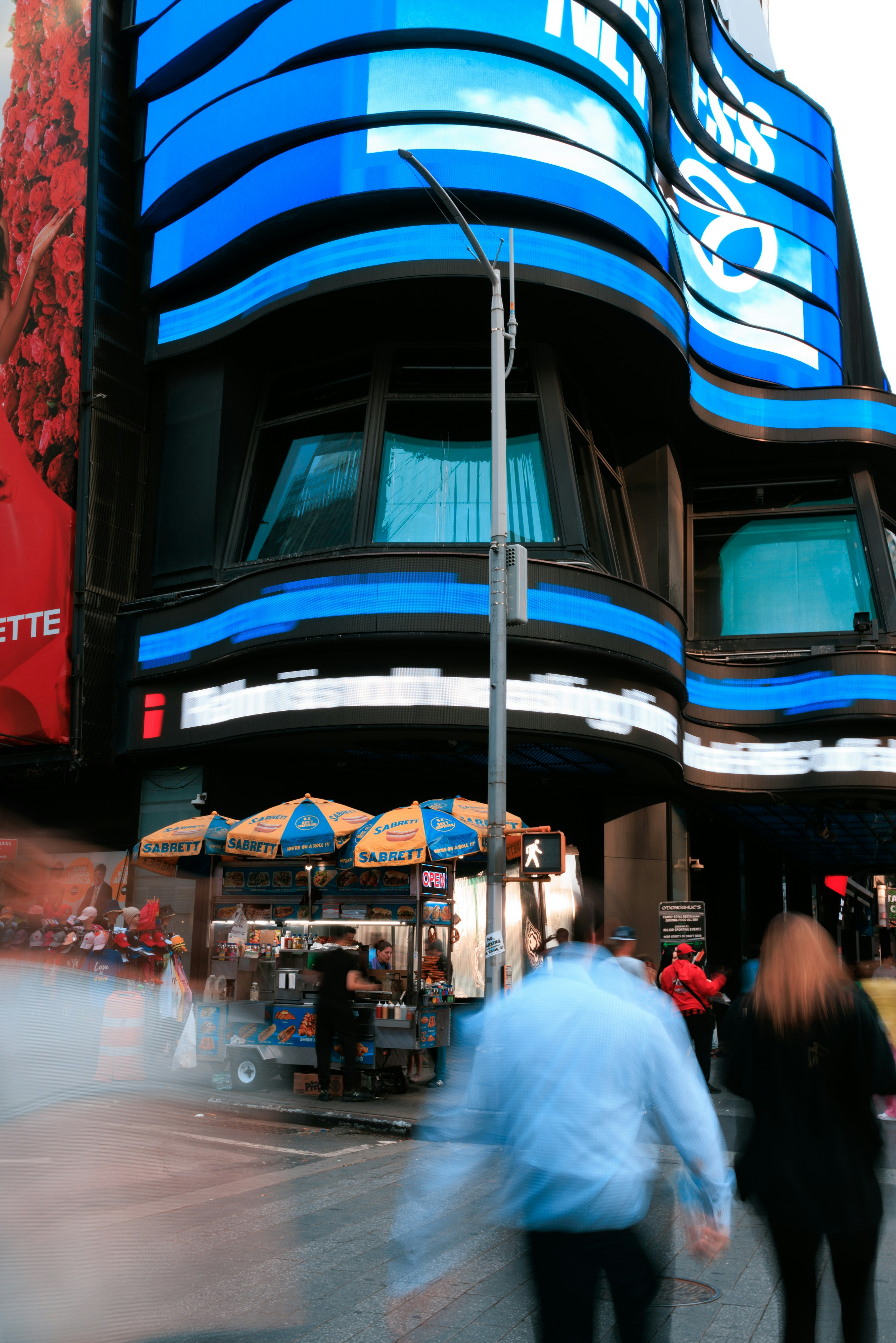 a blurry photo of people walking in front of a building